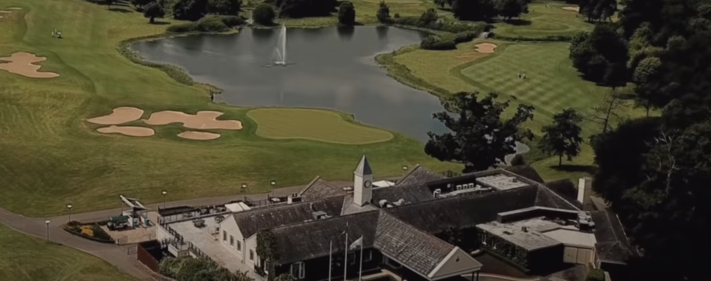 Aerial view of a golf course with a fountain pond.